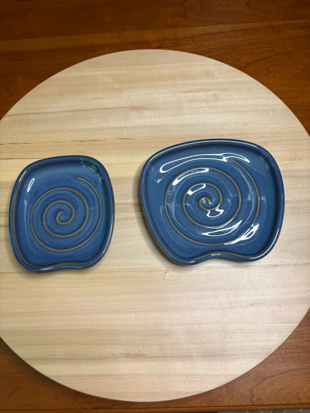 Pampered Chef Nesting Spoon Rest Set featuring a blue glaze with a swirl design.